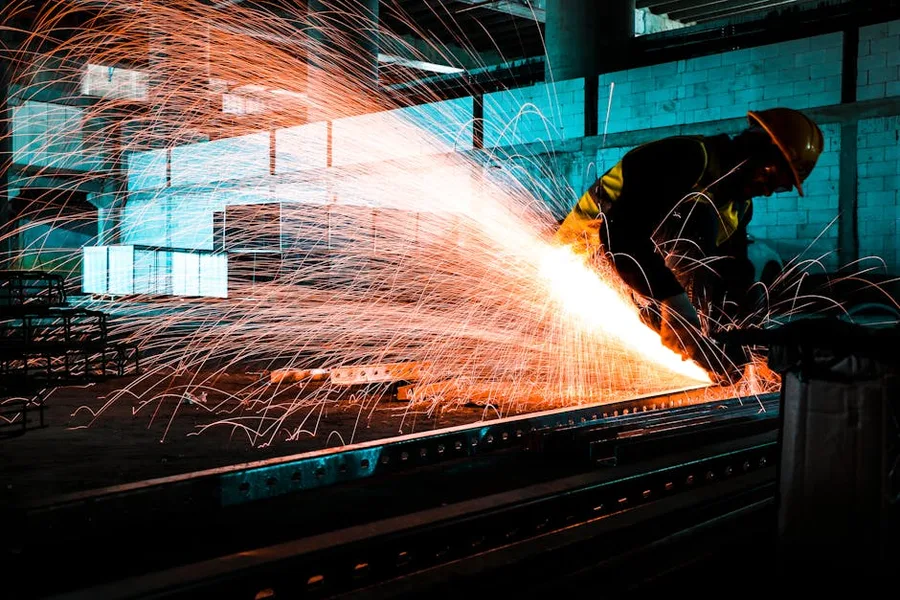 A fabricator cutting sheet metal on the shop floor