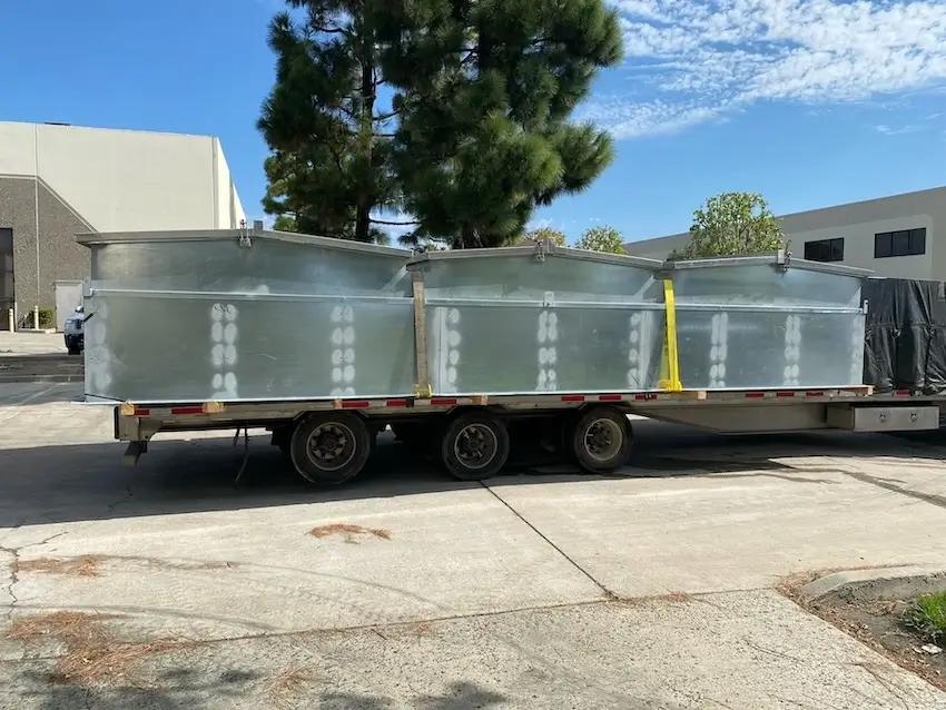 Fabricated curb units strapped to a flatbed trailer