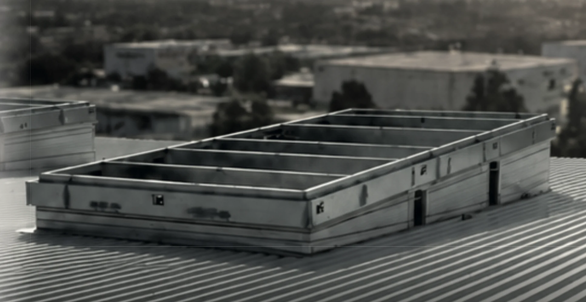 Fully welded roof curbs installed on the sloped metal roof of an active data center build