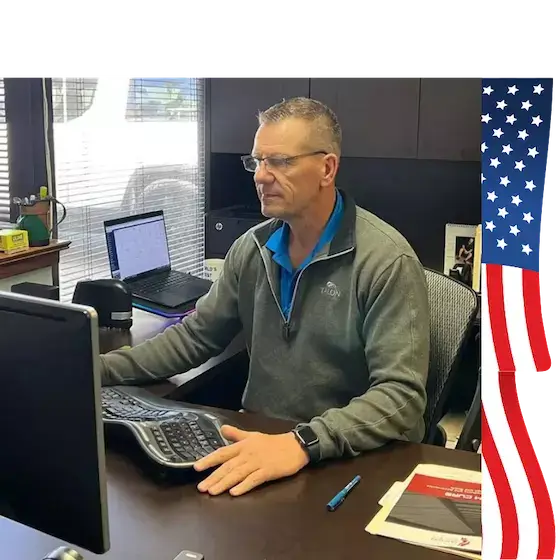 Jack Haas, founder and U.S. Navy veteran, at his desk at Custom Curb