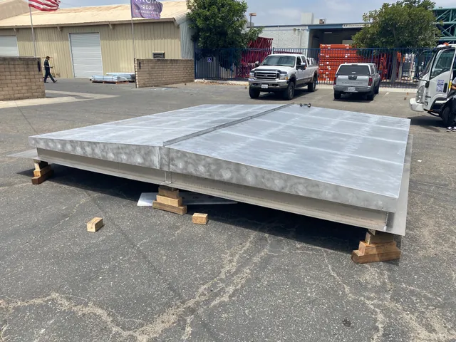 Galvanized equipment cover on blocks in the yard