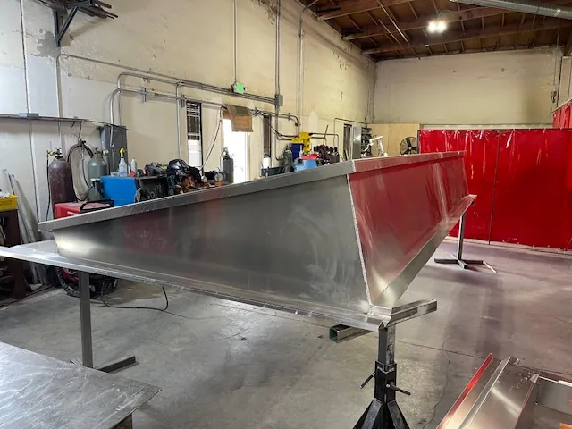 Long aluminum roof curb on the shop table