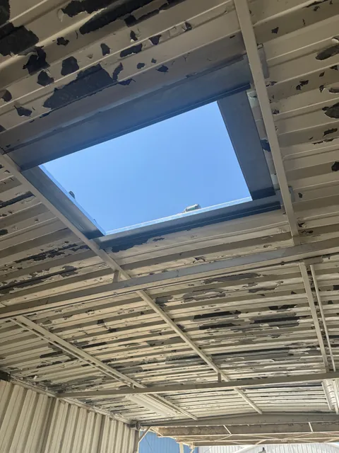 Roof curb opening seen from below the metal roof deck