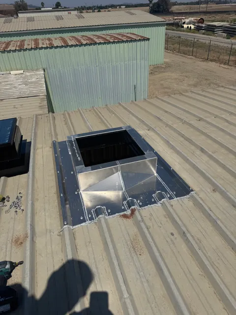 Pitch-corrected roof curb installed on a metal roof