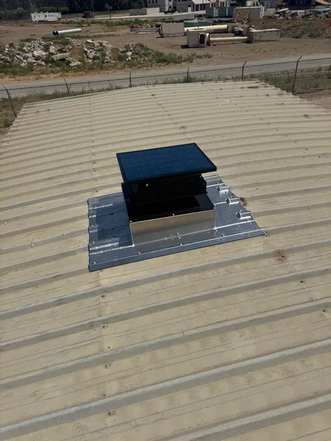 Insulated roof curb installed on a corrugated metal roof