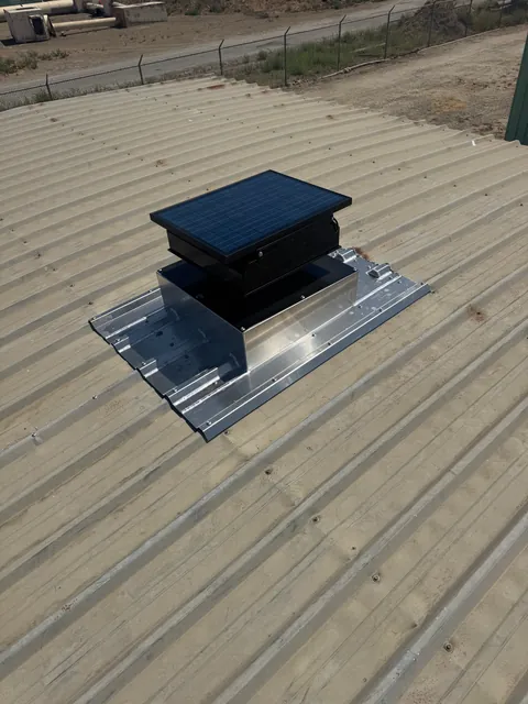 Roof curb with cover installed on a metal roof