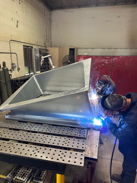 Welding a multi-pitch corrected curb adapter in the Custom Curb shop
