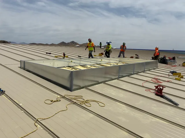 Installation crew setting a large roof curb with removable cover