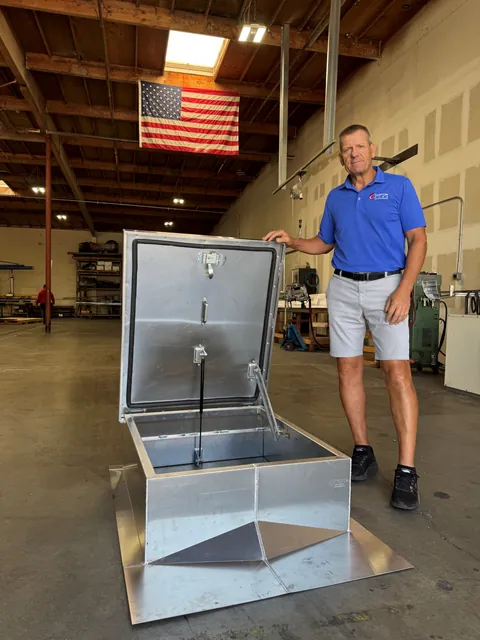 Jack Haas with a roof access hatch in the Custom Curb shop
