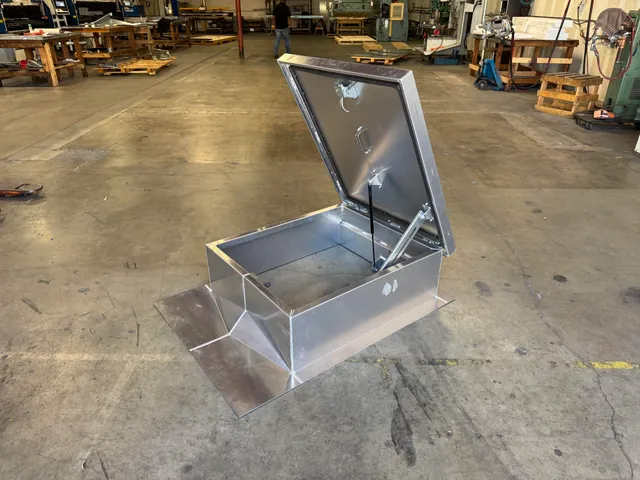 Aluminum roof hatch open, showing the gas spring operator
