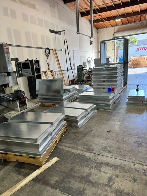 Smoke hatches stacked in the Custom Curb shop